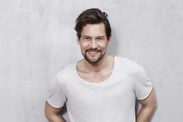 Happy young man in studio, smiling