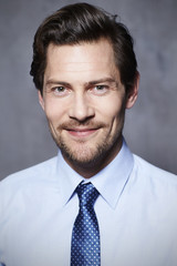 Confident businessman in blue, smiling