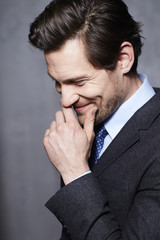 Smiling businessman in suit, close up