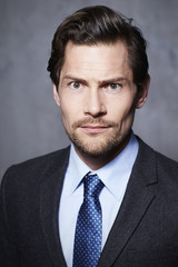 Uncertain businessman looking at camera