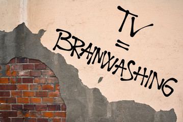 Handwritten graffiti TV = Brainwashing sprayed on the wall, anarchist aesthetics. Appeal to avoid...