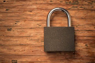 Fototapeta premium padlock on a vintage wooden board