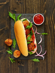 Homemade meatballs with tomato sauce filed in hamburger buns.