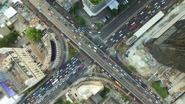 aerial top view of traffic and vehicle car on crossroad or junction in bangkok city area at twilight sunset, 90 degree shot, High quality footage 4K