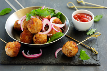 Homemade meatballs with tomato sauce and salad.