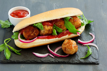 Homemade meatballs with tomato sauce filed in hamburger buns.