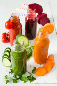 Selection of colorful vegetable juices in glass jars