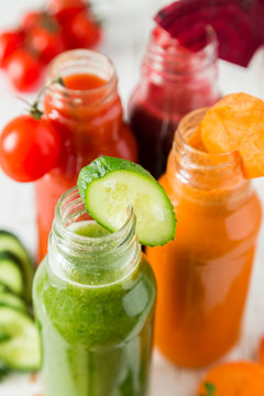 Selection of colorful vegetable juices in glass jars