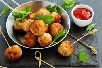 Homemade meatballs with tomato sauce and salad.