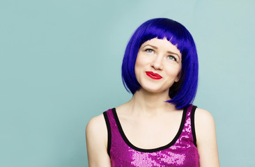 Portrait of happy beautiful young woman thinking looking away up