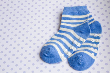 Baby blue background with baby socks with copy space for Your message