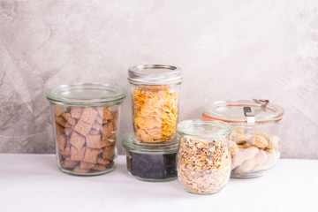 Assortment of cereals and nuts in storage jars