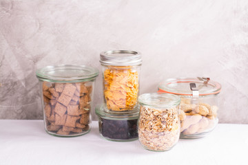Obraz na płótnie Canvas Assortment of cereals and nuts in storage jars