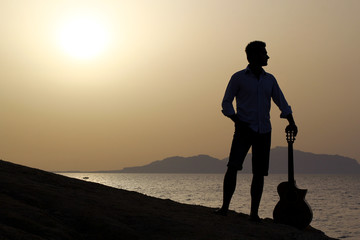 guitarist with guitar and sunrise