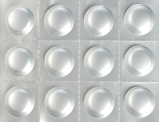 Medical background - pile of pills in blister packs