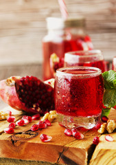 Fresh pomegranates and juice, selective focus