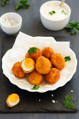 Quail eggs, deep fried with white sauce.