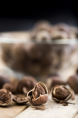Close-up of hazelnuts on wooden table. Some broken, shelled, some whole