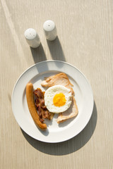 Breakfast set eggs, ham, sausage with morning light.