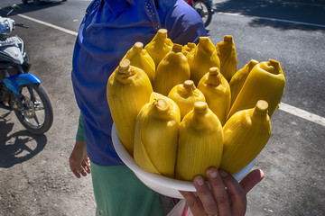 A street vender selling boiled corn on the cobs  in Bedugul, Bali
