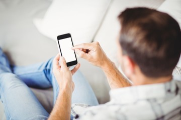 Rear view of man using mobile phone