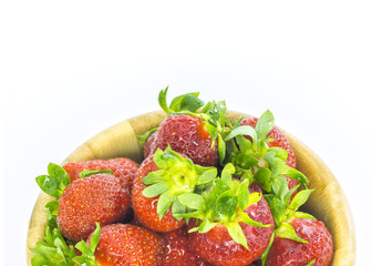 fresh whole strawberries in wooden bowl