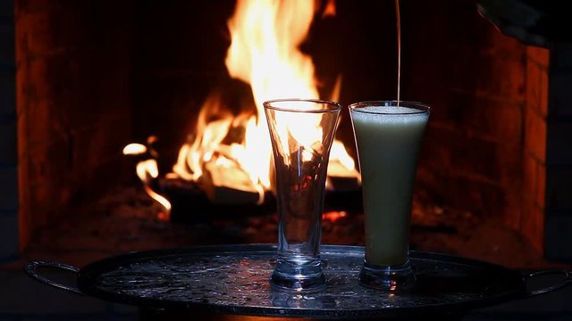 two beers  with flame on background