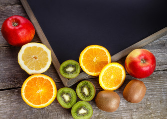 Fresh fruits oranges, kiwi, lemons, apples arranged in a group, natural still life for healthy food. Top view. Empty space for text.