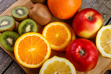Fresh fruits oranges, kiwi, lemons, apples arranged in a group, natural still life for healthy food.