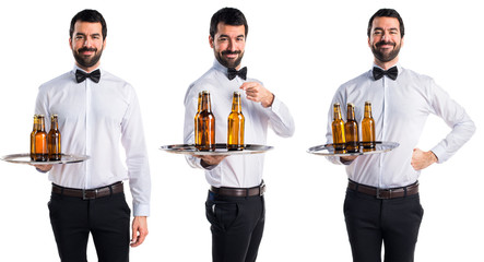 Waiter with beer bottles on the tray