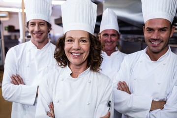 Group of happy chefs smiling at the camera 