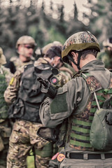 men in military uniform with weapon