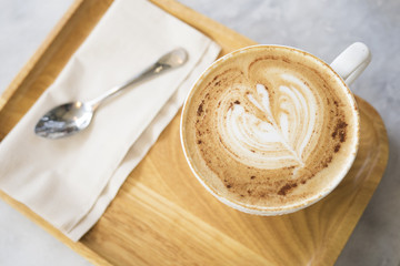 Fototapeta na wymiar Cup of coffee on table in cafe