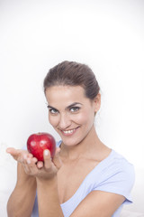 Beautiful woman with red apple in hand