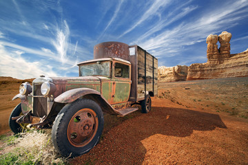 rusted abandoned truck in a rocky desert landscape