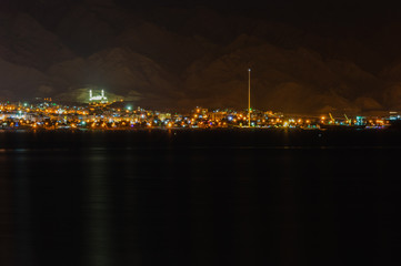 Aqabah, the Jordanian seaport city at night, as seen from the neighbouring city Eilat of Israel.