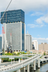Brisbane city sweeping interchange roading along river edge and high rise buildings