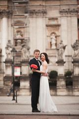 Bride and groom on the background of beautiful church. Beautiful old building. Arch. Wedding