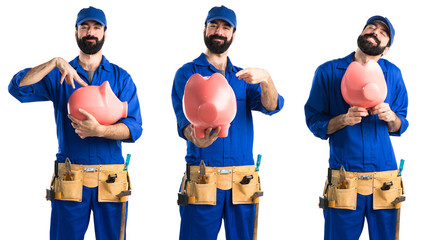 Plumber holding a piggybank