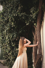 Beautiful girl with long hair posing near tree in vavel Krakow
