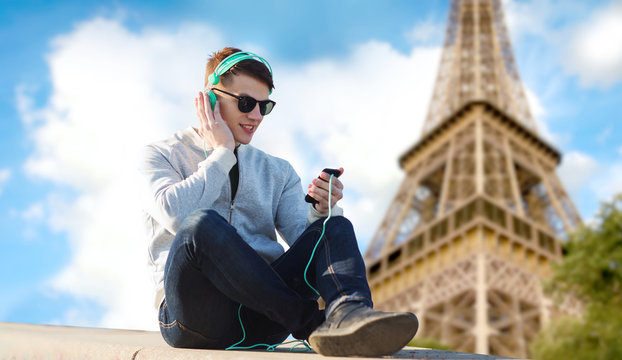 happy young man in headphones with smartphone - Powered by Adobe