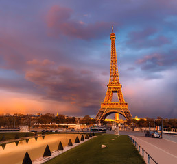 Eiffel tower on a sunset half-lit with last rays of the setting