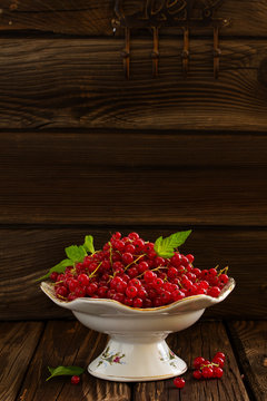 Berries red currants on a wooden background.