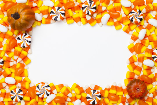 image of arranged candy corns and pumpkins.