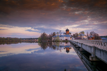 Fototapeta premium Beautiful landscape. Russian Orthodox church at sunset. The arch