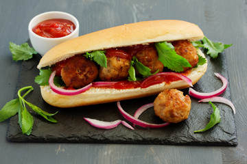 Homemade meatballs with tomato sauce filed in hamburger buns.