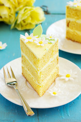 A piece of lemon sponge cake on a plate.