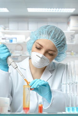 Young female tech or scientist loads liquid sample