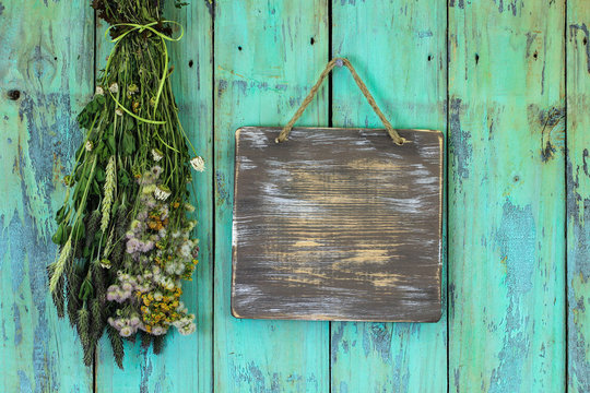 Blank Wood Sign Hanging By Bouquet Of Dried Flowers