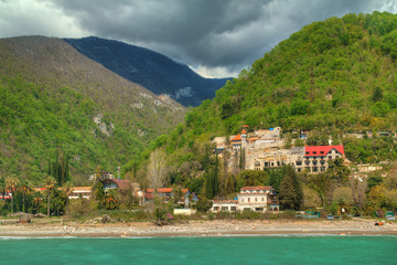 Fototapeta na wymiar View of mountains and old town Gagra, Abkhazia, HDR processing.